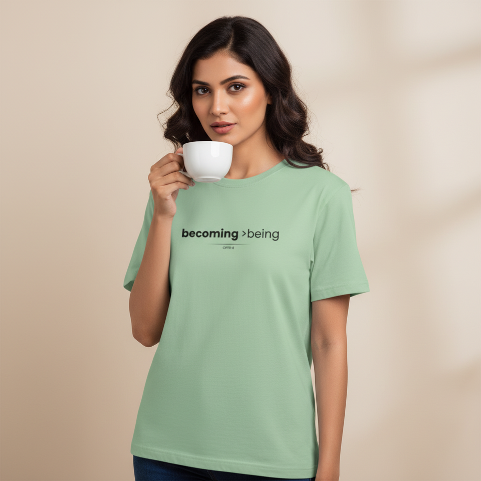 Woman wearing a green t-shirt with text, holding a cup against a beige background - View 2